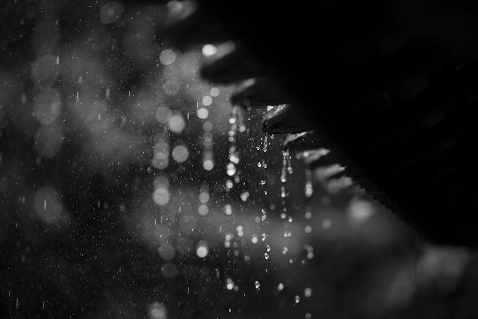 Captivating black and white photo of rain droplets cascading from a roof in Vietnam.